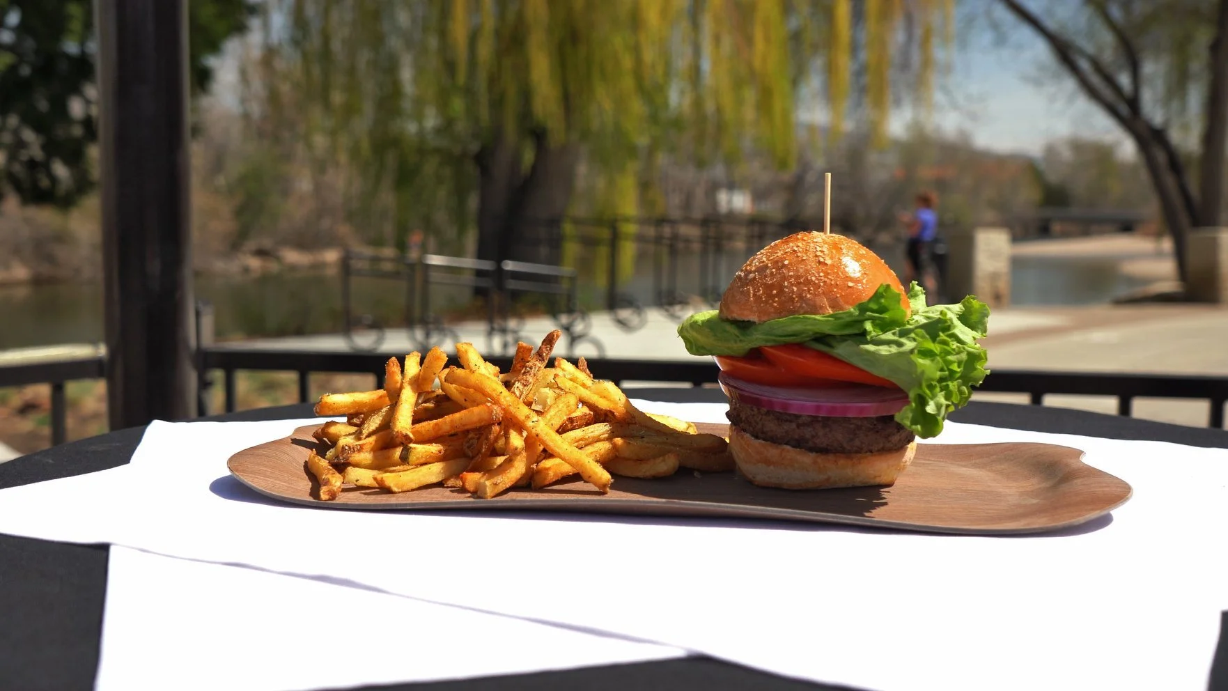 Sandbar Patio Bar and Grill signature dishes  Riverside Burger, Fish Tacos, various salads and sandwiches, specialty cocktails.
